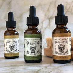 supreme blend beard oil bottles with beard brush