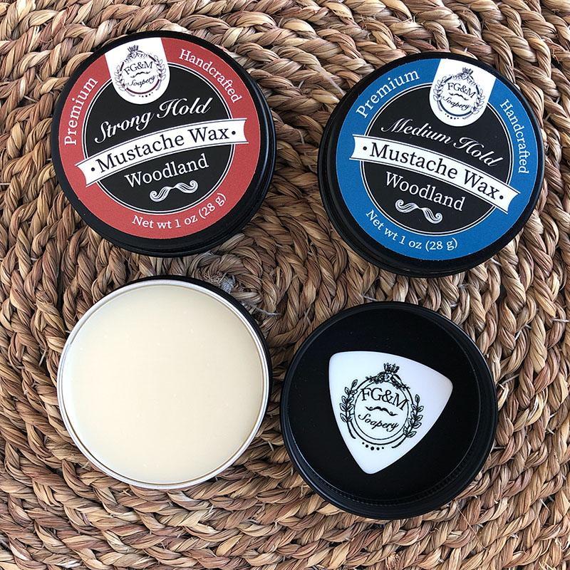 strong hold mustache wax and medium hold mustache wax in 1oz black tins